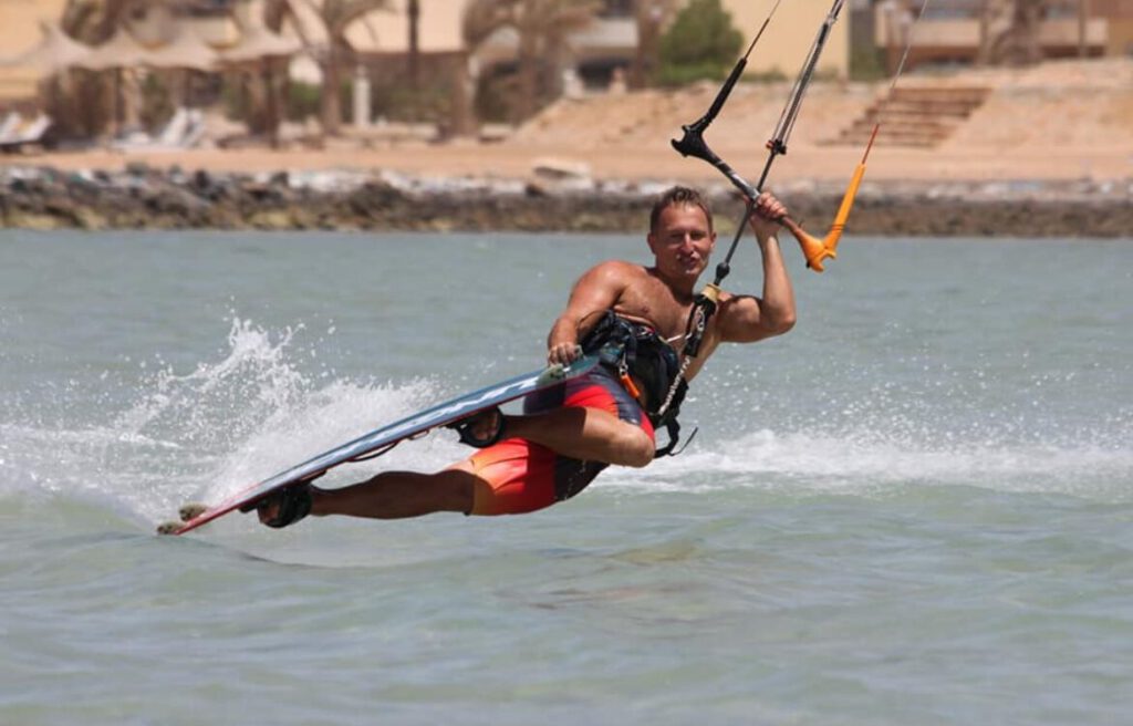 Kitesurfer carving through spray on the flat-water lagoon in Hurghada