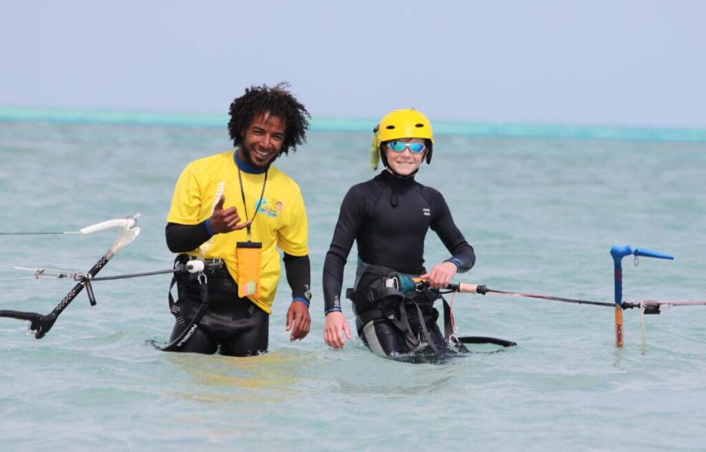 Sultan Kite School instructor with a student in a helmet during a kitesurfing lesson in the Hurghada lagoon