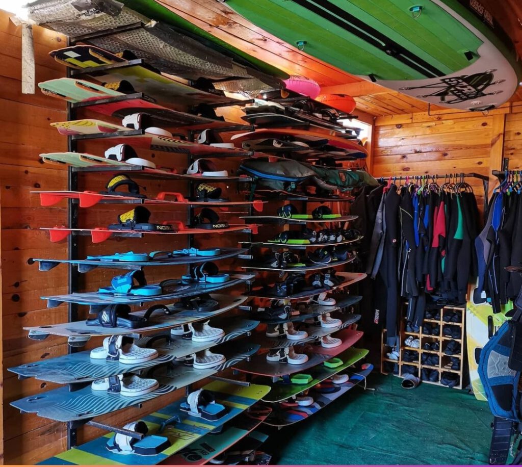 Kite storage room at Sultan Kite School in Hurghada with kiteboards on racks and wetsuits