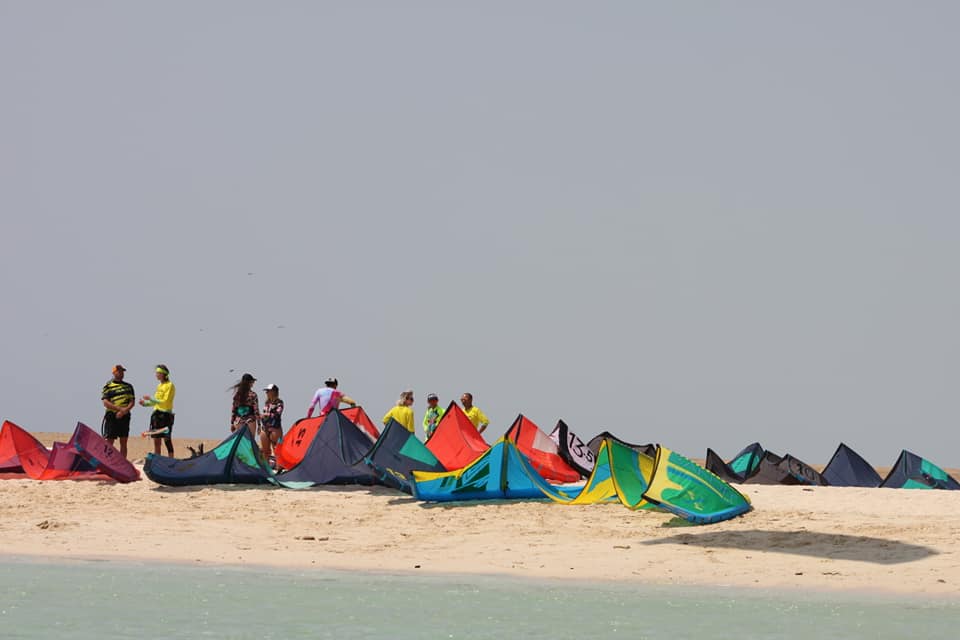 Row of kites pumped up on a remote Red Sea beach during the kite safari