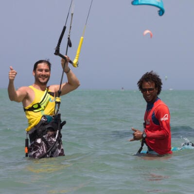 Kitesurfing instructor and student standing in the shallow lagoon in Hurghada