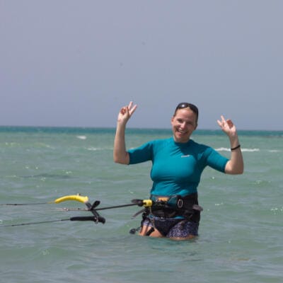 Happy student waving during a kitesurfing lesson in the Hurghada lagoon